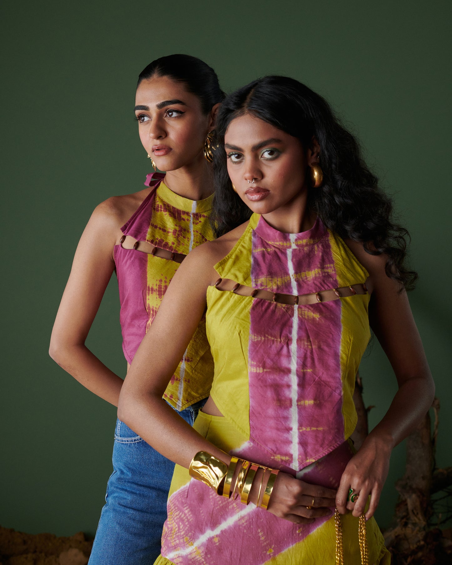 Two women wearing Khatta Jaljeera Top in hand-dyed mustard yellow and deep pink halter-neck design from Naarangi’s Chaska collection.