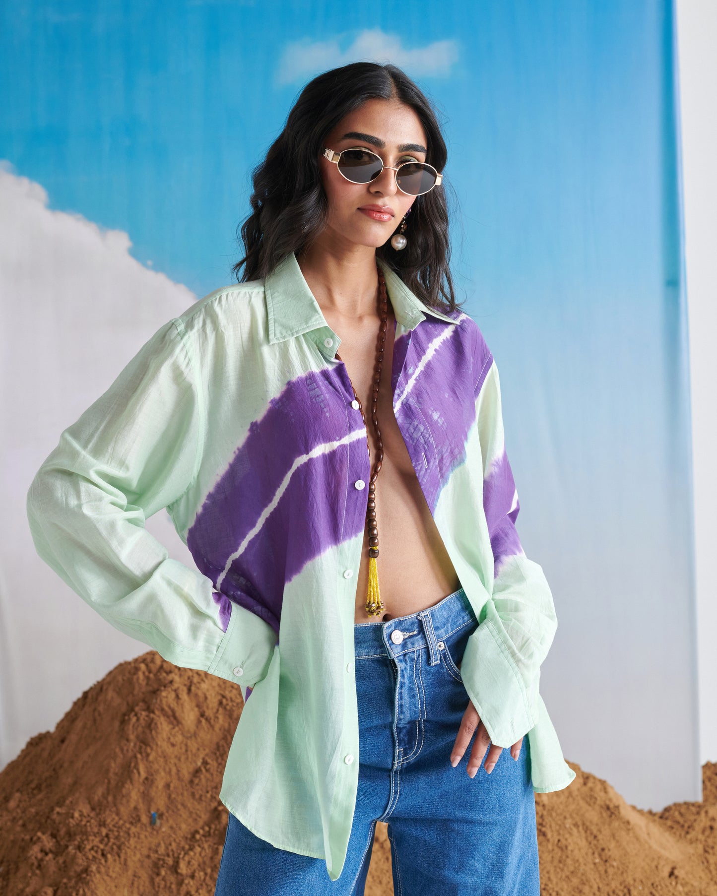 Woman posing in Naarangi Aasmani Leher blue shirt, relaxed casual fashion look.