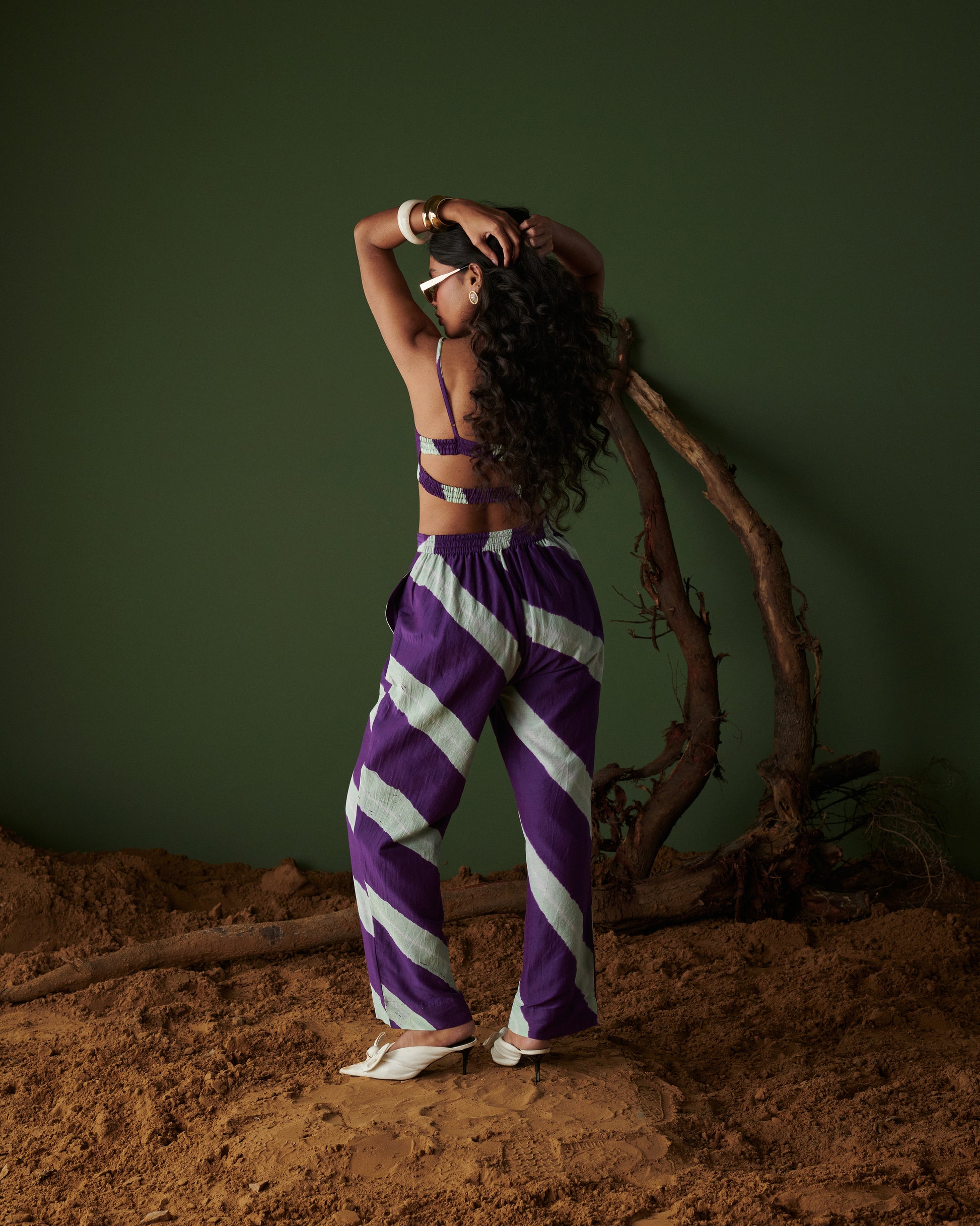 Naarangi Jamun Swirl Pants in purple with bold white swirl stripes, stylish back view with crop top and trendy design.