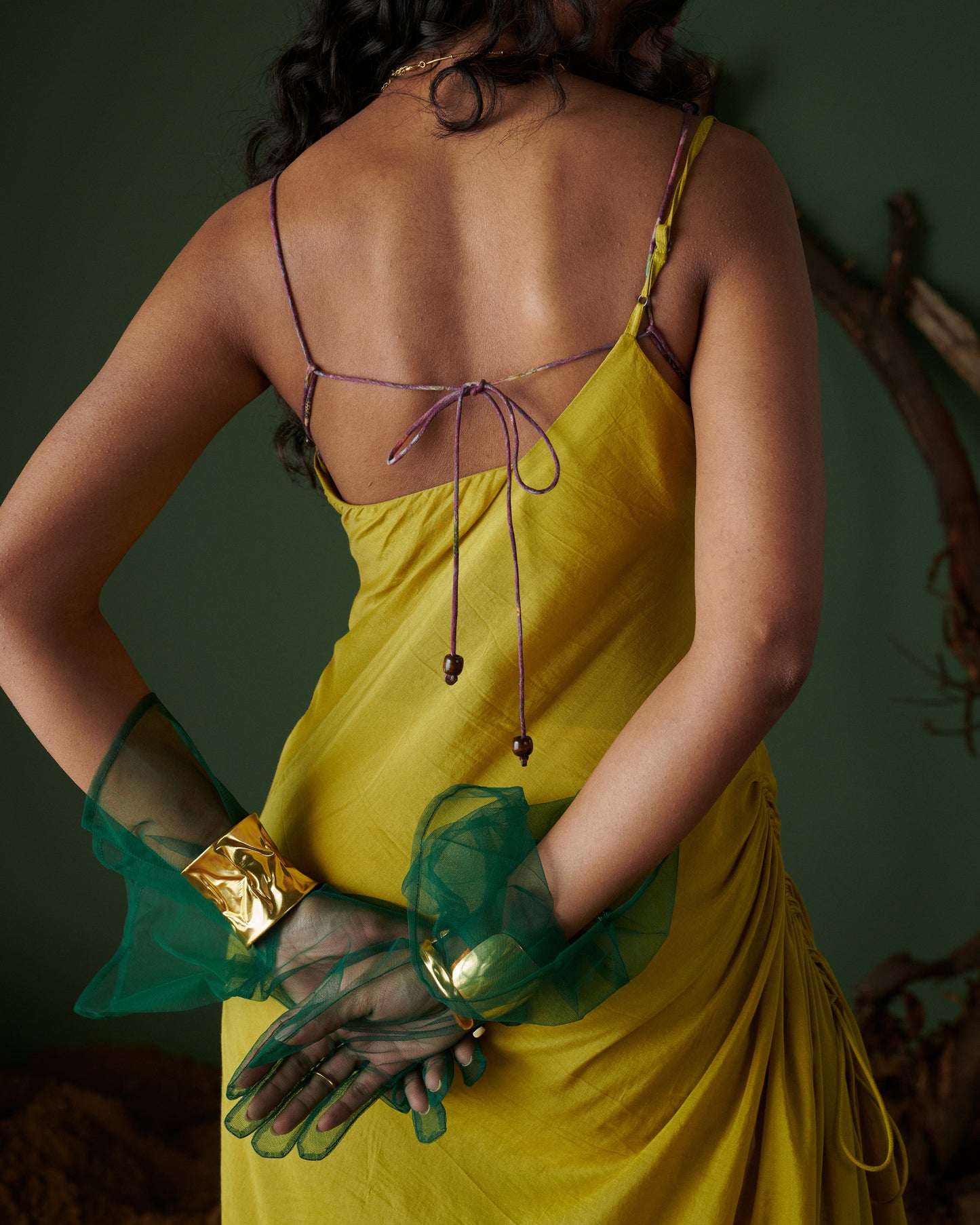 Back view of Sunheri Zest Dress in yellow featuring delicate tie-up straps and elegant drape by Naarangi.