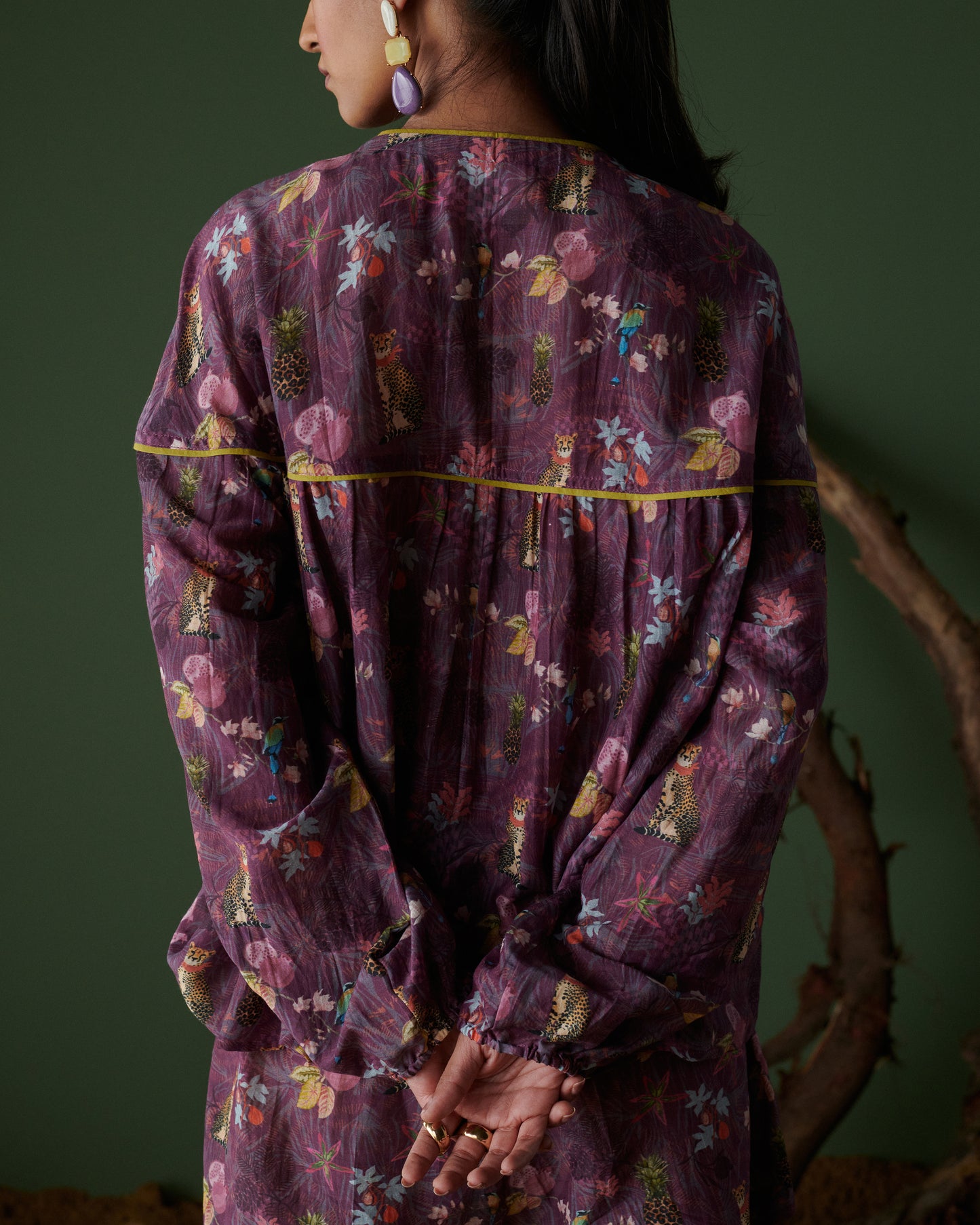 Back view of Tropical Ras purple floral top showcasing flowy fabric and vibrant print.