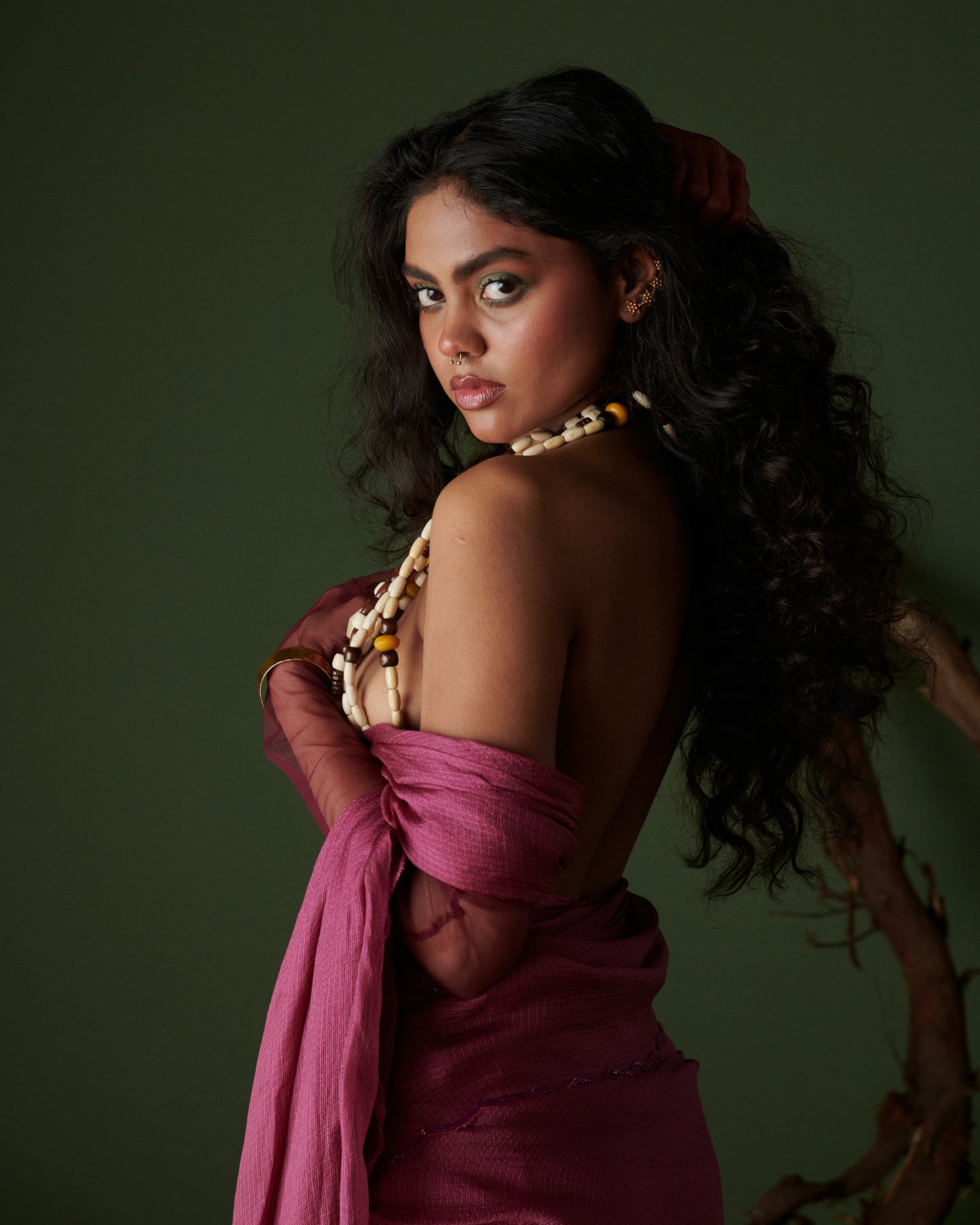 Back profile of Kokum Crush plum saree with blouse by Naarangi, handwoven airy drape styled with beads jewelry.