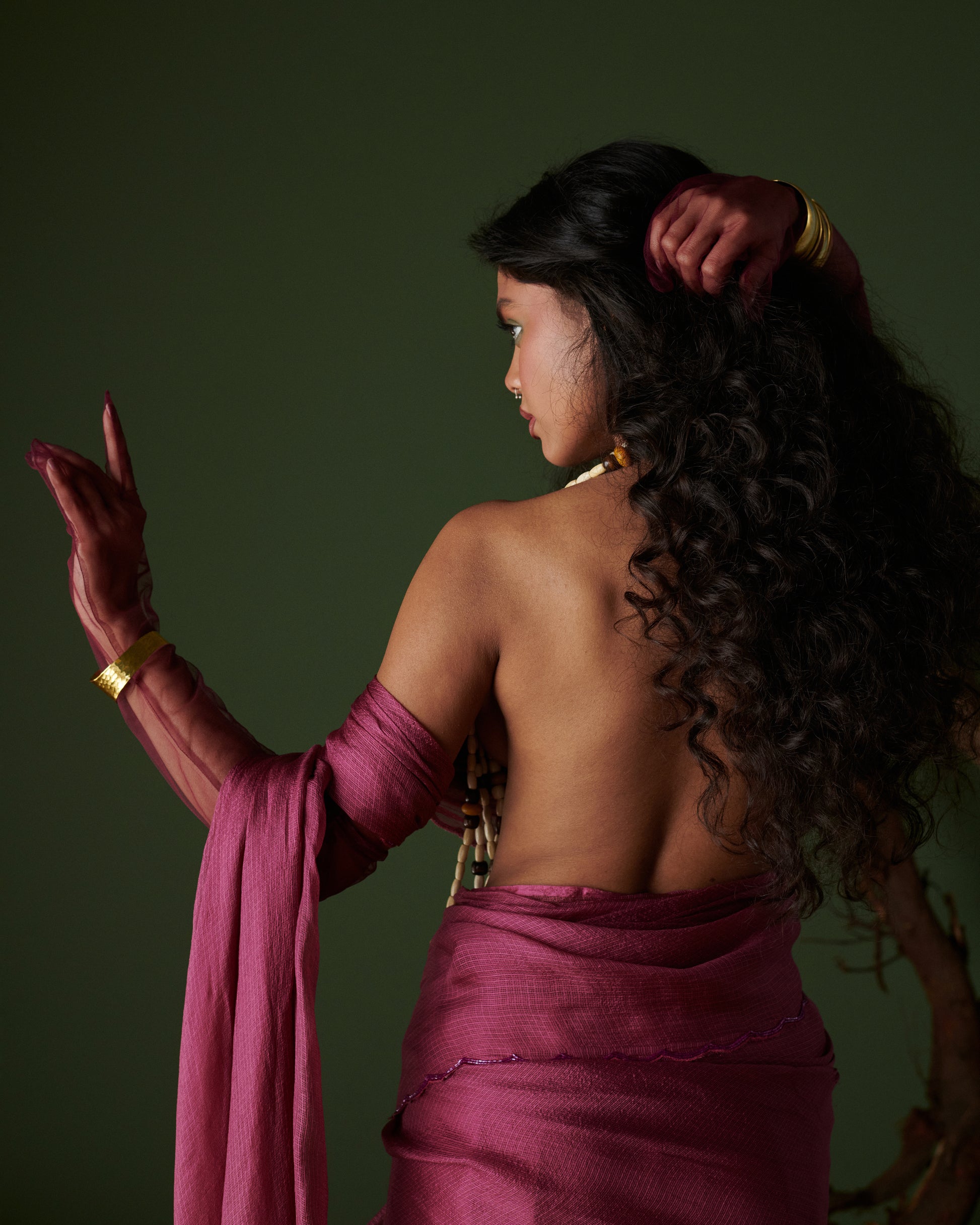Back profile of Kokum Crush plum saree with blouse by Naarangi, airy handwoven drape styled with beads and bangles.