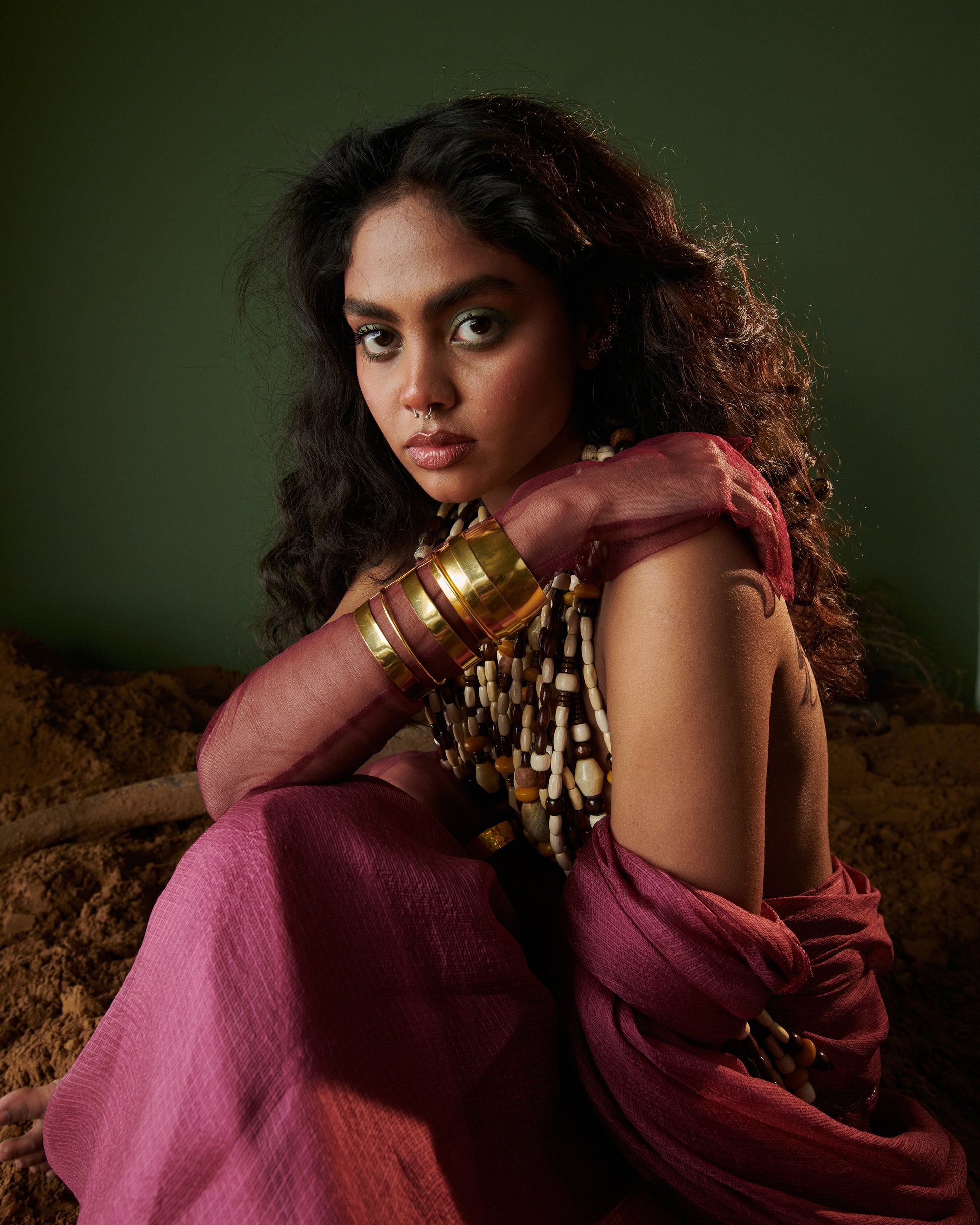Close-up of Kokum Crush plum saree with blouse by Naarangi, handwoven airy fabric styled with jewelry and bangles.