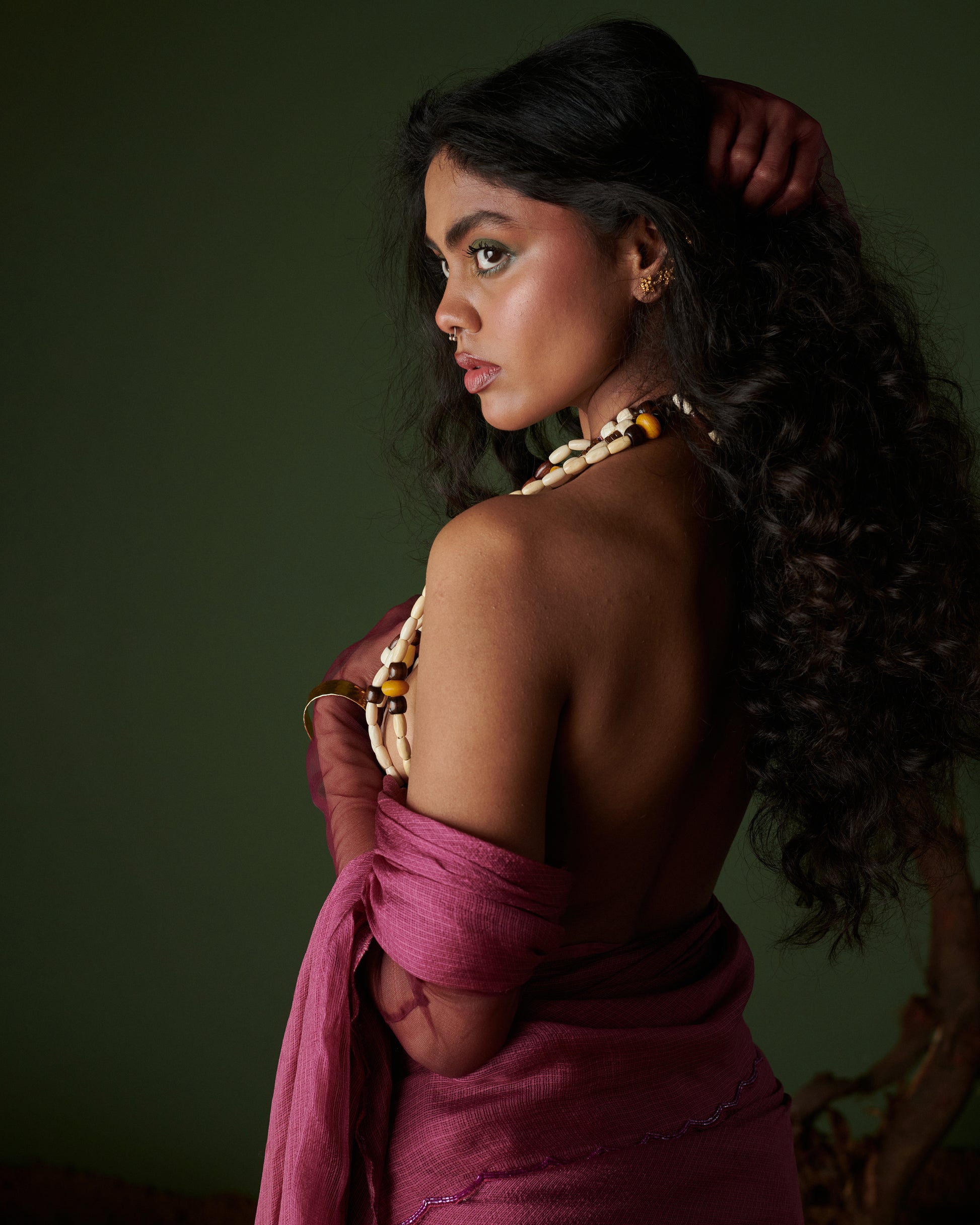 Side profile of model in Kokum Crush plum saree by Naarangi, airy handwoven drape with aari border styled for bold look.