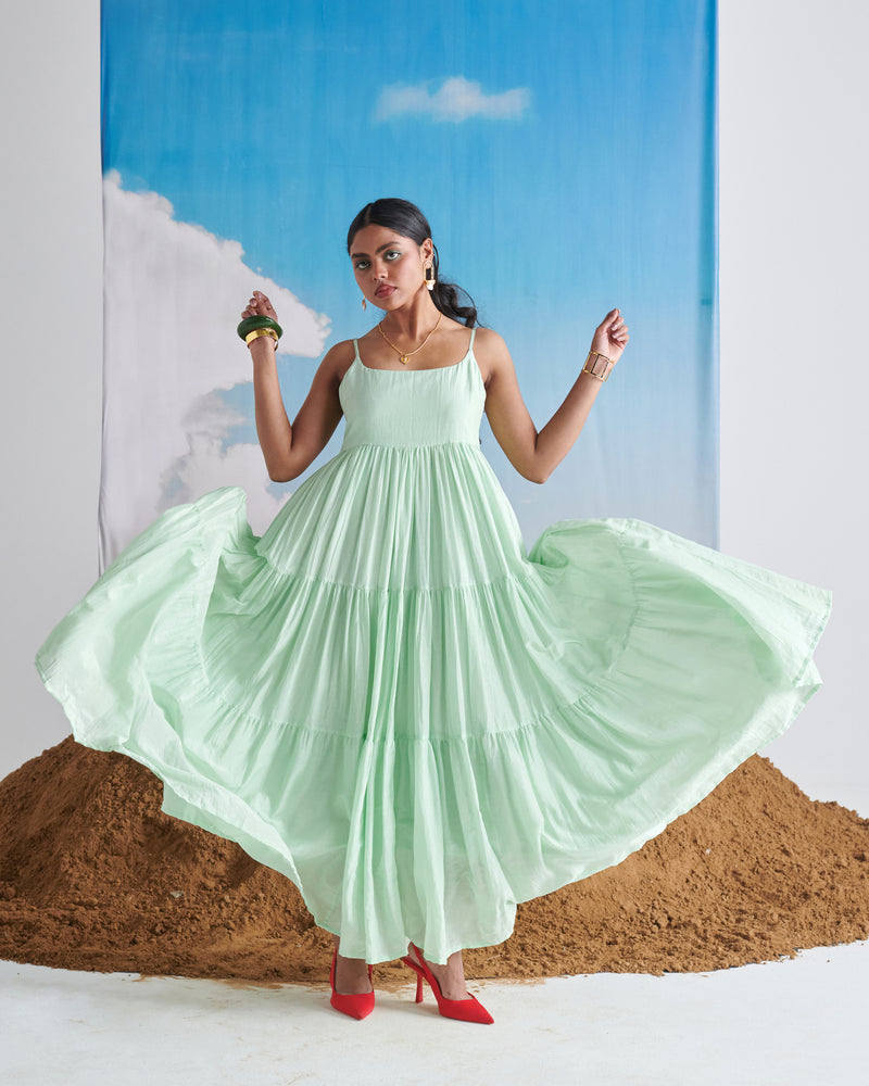 Woman twirling in Minty Mehfil green maxi dress with flowing tiered layers.