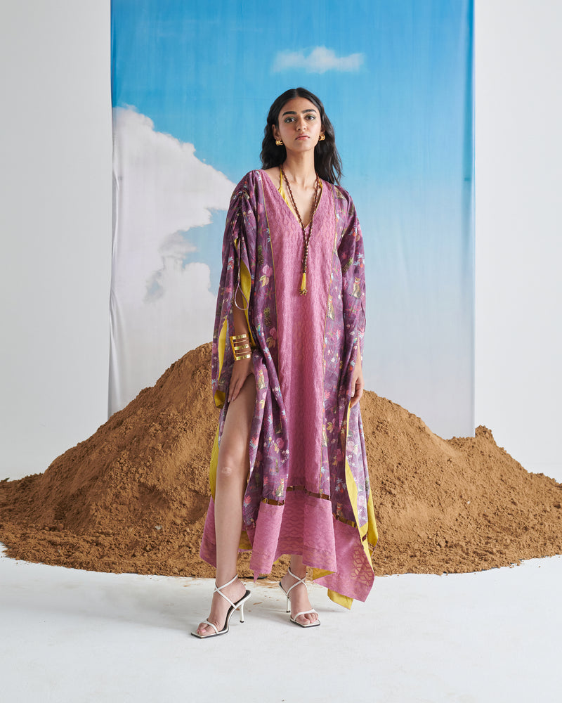 Model wearing Naarangi Falsa Fantasy kaftaan with purple shades and flowing design, front pose.