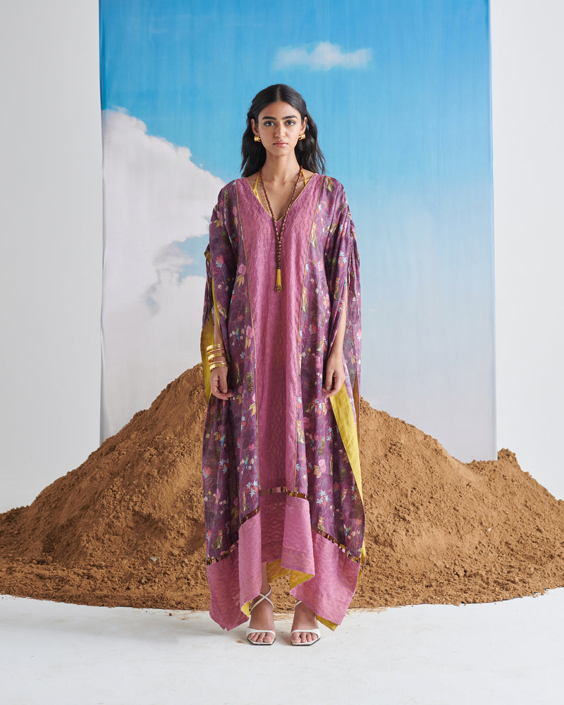 Full length view of woman in Naarangi Falsa Fantasy kaftaan with soft purple hues.