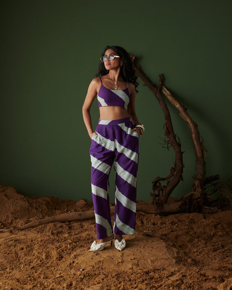 Naarangi Jamun Swirl Pants in purple with white swirl stripes, styled with matching crop top for a coordinated modern look.