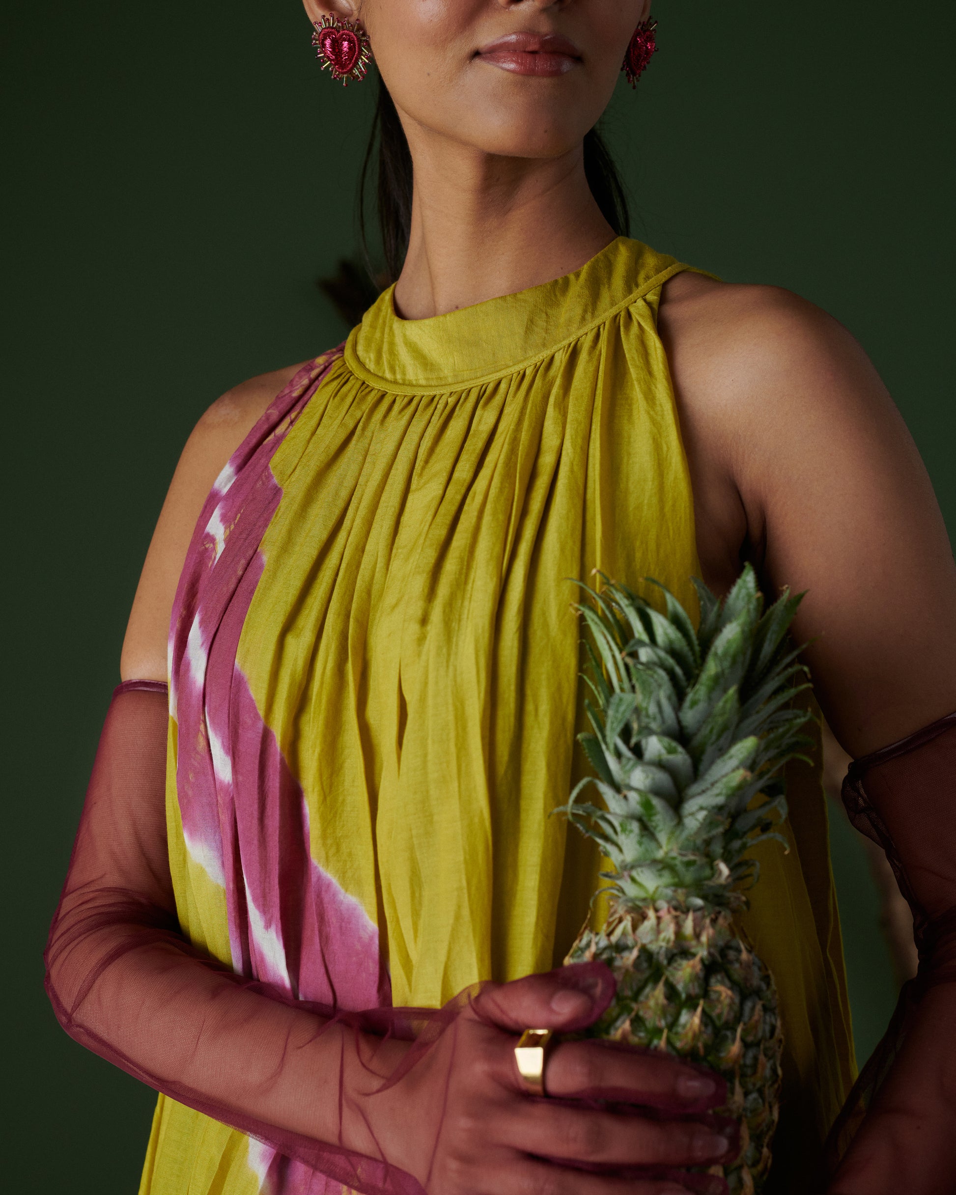 Close-up of Naarangi Nimbu Twist yellow dress with pink tie-dye and accessories.