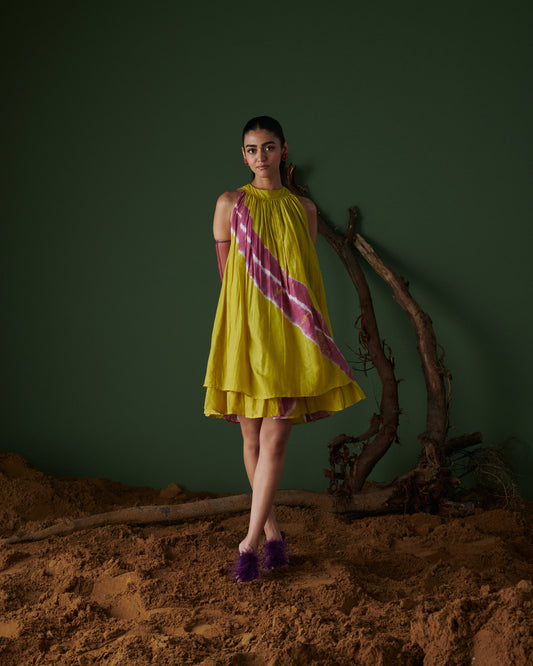 Elegant front pose of model in Naarangi Nimbu Twist dress, yellow with pink stripes.