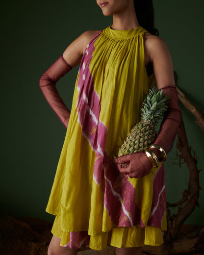 Stylish model wearing Naarangi Nimbu Twist yellow dress with pink detailing, front pose.