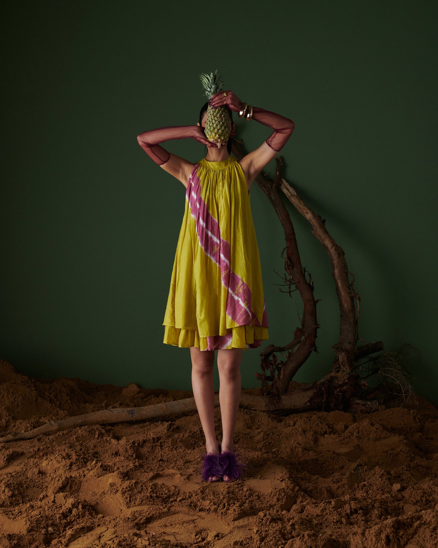 Full front view of model wearing Naarangi Nimbu Twist yellow dress with pink pattern.