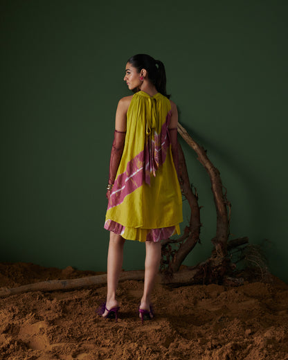 Model showcasing Naarangi Nimbu Twist yellow dress with pink tie-dye detail, back view.
