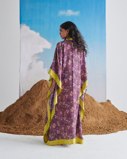 Back view of model wearing Plum Passion kaftaan with lime border and all-over plum print.