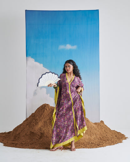 Front view of Plum Passion kaftaan holding a fan to the side, tropical print visible.