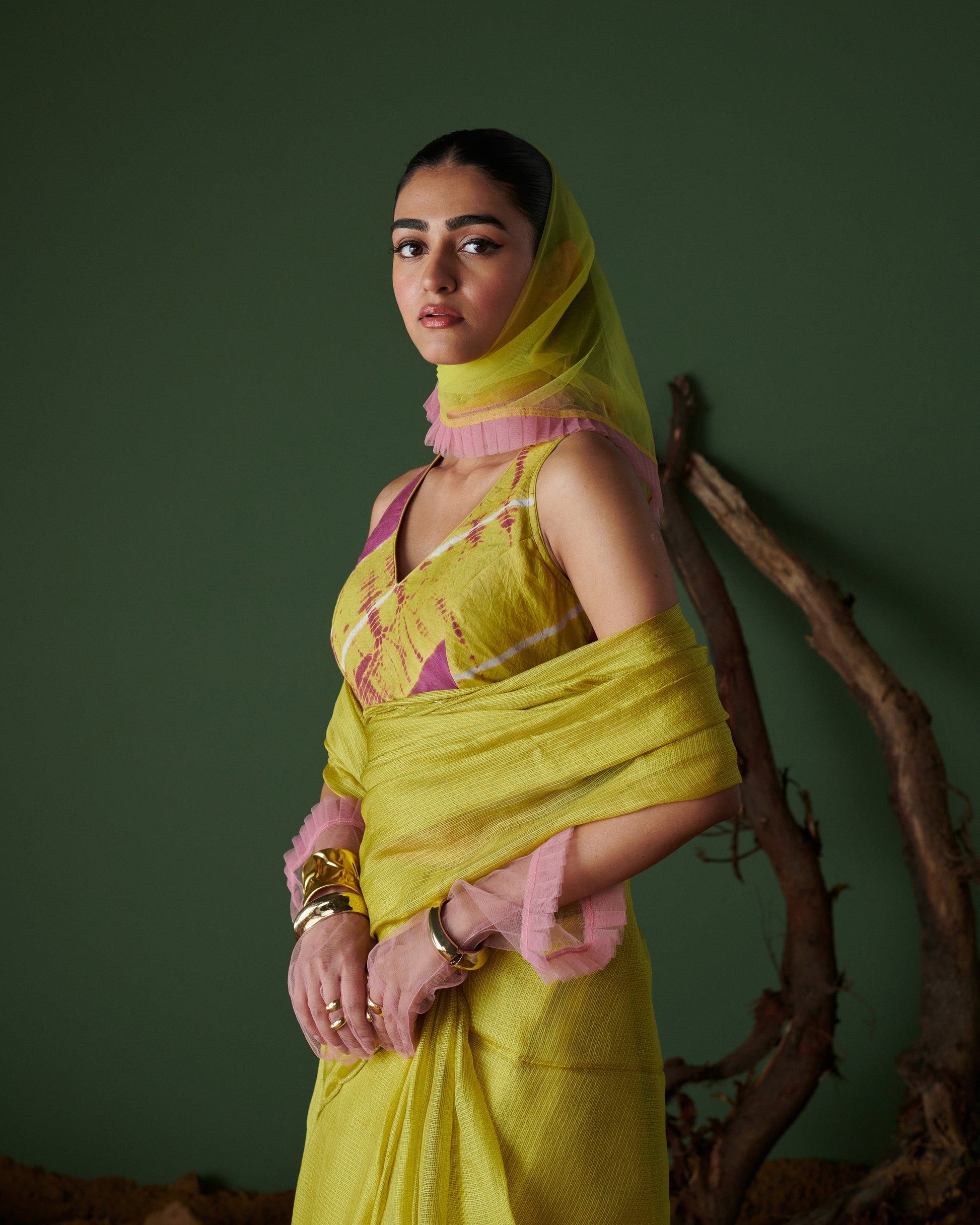 Elegant side view of model in Nimbu Soda Pop saree with blouse by Naarangi, lime yellow saree with magenta blouse, festive ethnic wear India.