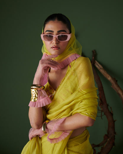 Stylish model in Nimbu Soda Pop saree with blouse by Naarangi, lime yellow saree with magenta blouse and pink sunglasses, modern ethnic wear India.