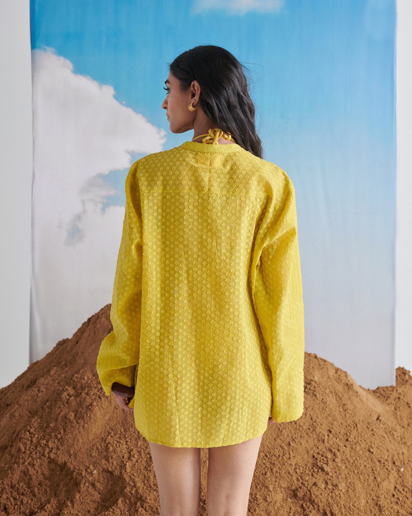 Back view of Tangy Tadka Kurta in bright yellow, showcasing textured weave fabric, long sleeves, and minimal rear design.