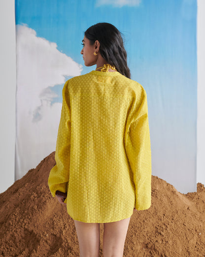 Back view of Tangy Tadka Kurta in bright yellow, showcasing textured weave fabric, long sleeves, and minimal rear design.