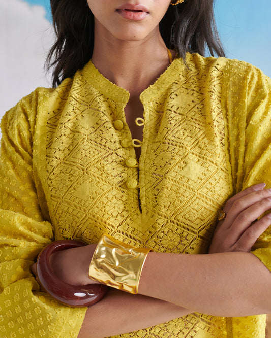 Close-up view of Tangy Tadka Kurta in bright yellow, featuring textured fabric, button placket and elegant detailing.