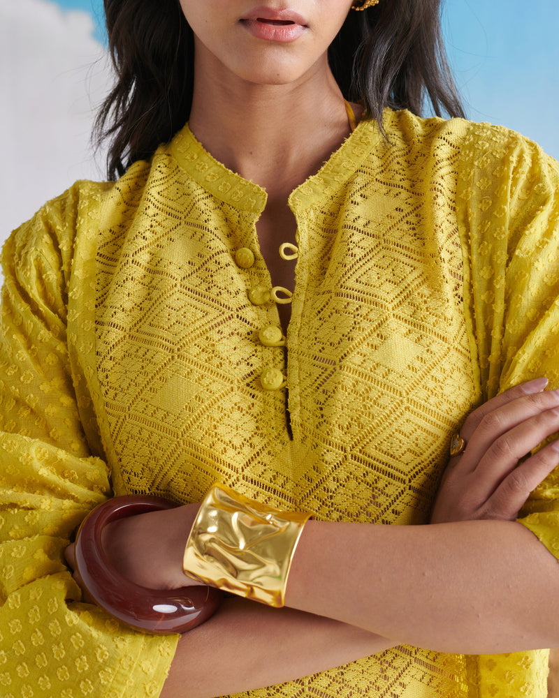 Close-up view of Tangy Tadka Kurta in bright yellow, featuring textured fabric, button placket and elegant detailing.